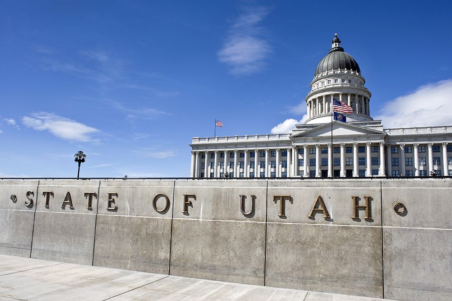 Utah state capitol building with STATE OF UTAH sign out front